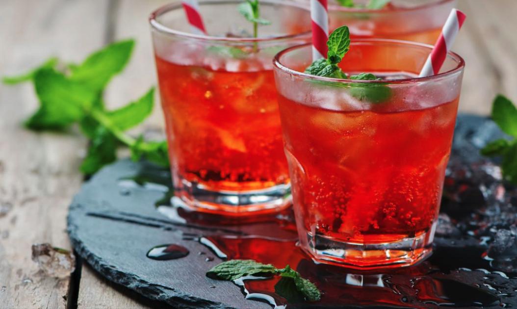 Deux verres de boisson fruitée glacée avec pailles et menthe